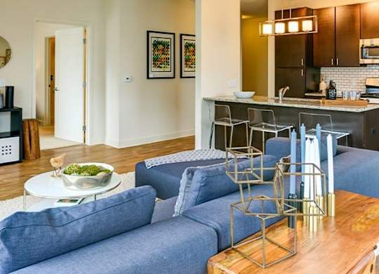 a living room with a blue couch and a table