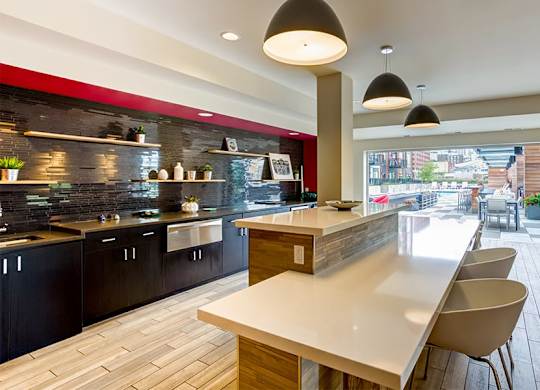a kitchen with a long counter and a table and chairs
