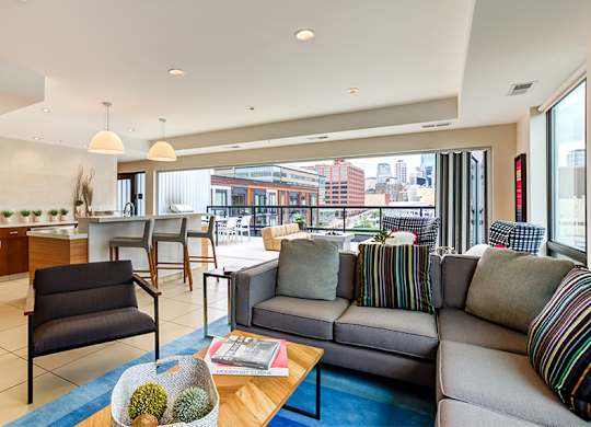 A living room with a couch, chairs, and a coffee table.