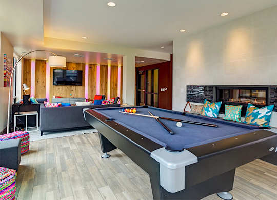 a game room with a pool table and a tv