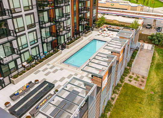 A modern building with a pool and a glass wall.