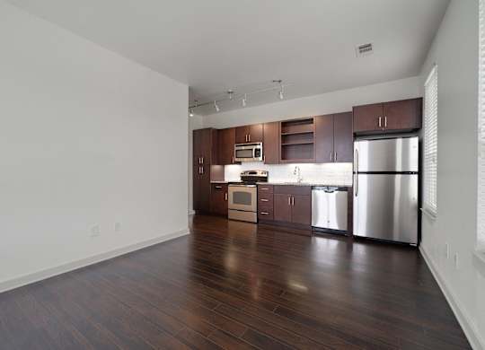 12 South Apartments - Nashville TN - kitchen with dark wood cabinets and stainless steel appliances