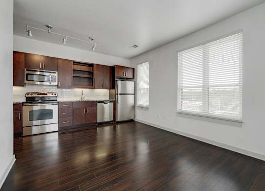 12 South Apartments - Nashville TN - kitchen with dark wood cabinets and stainless steel appliances