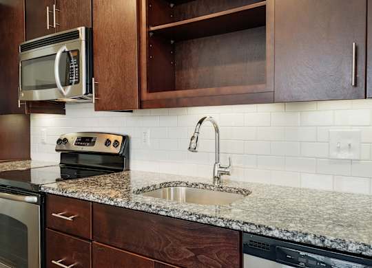12 South Apartments - Nashville TN - kitchen with dark wood cabinets and stainless steel appliances