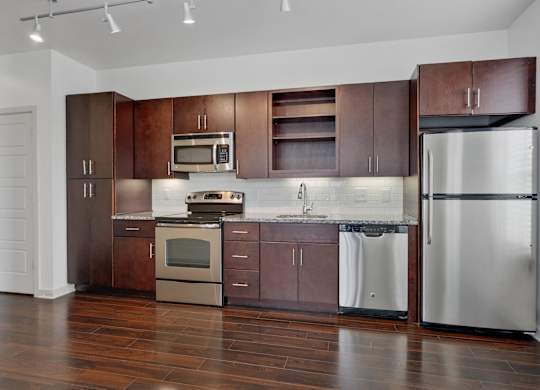 12 South Apartments - Nashville TN - kitchen with dark wood cabinets and stainless steel appliances