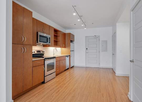 12 South Apartments - Nashville TN - kitchen with dark wood cabinets and stainless steel appliances
