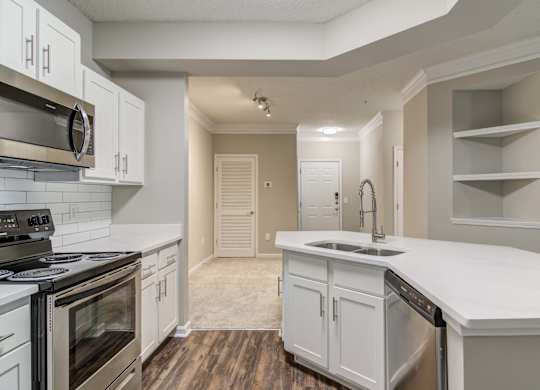 Apartments In Woodstock for Rent – Lea Woodstock – Luxury kitchen with kitchen island, stainless steel appliances, white cabinets.