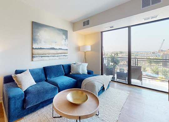 a living room with a blue couch and a table