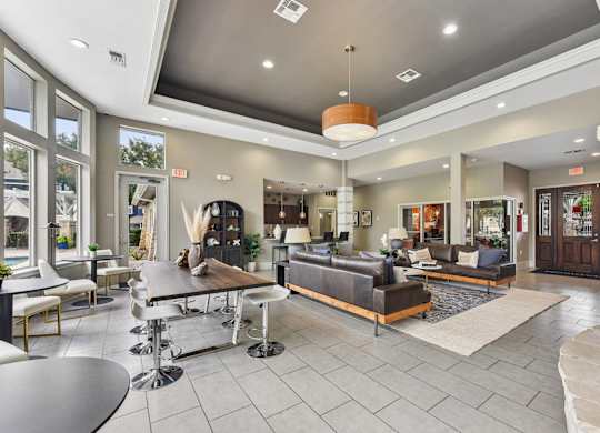 A spacious living room with a variety of seating options and a coffee table.