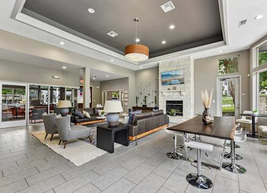 A modern living room with a stone fireplace and a large dining table.