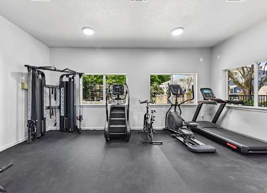 A spacious home gym with a variety of exercise equipment.
