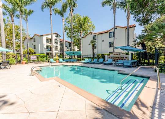 our apartments have a swimming pool with chairs and umbrellas