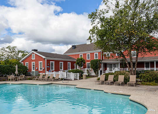 Orchards Apartments Marlborough ma apartment loft style apartments photo of  pool with lounge chairs and red siding clubhouse in background