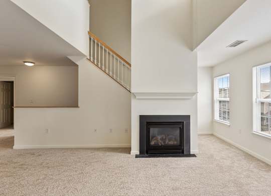 Orchards Apartments Marlborough ma apartment loft style apartments photo of living room with fireplace and stairs with carpet flooring and multiple windows