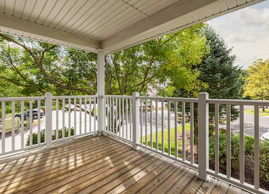 Orchards Apartments Marlborough ma apartment loft style apartments photo of large private outdoor balcony with wood floor and white railings overlooking green trees and landscape