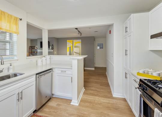 Orchards Apartments Marlborough ma apartment loft style apartments photo of kitchen stainless steel dishwasher and wood floors and white cabinets with dining room and living room with fireplace in background