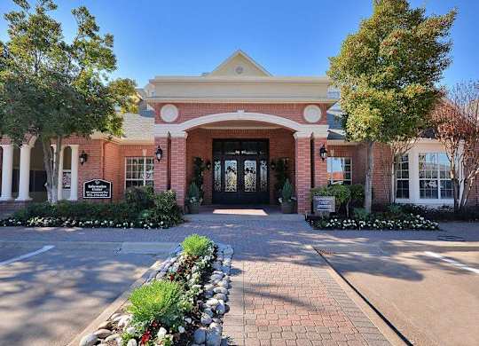 Plano, TX Apartments - Exterior View of Carrington Park Apartments Building Surrounded By Lush Landscaping