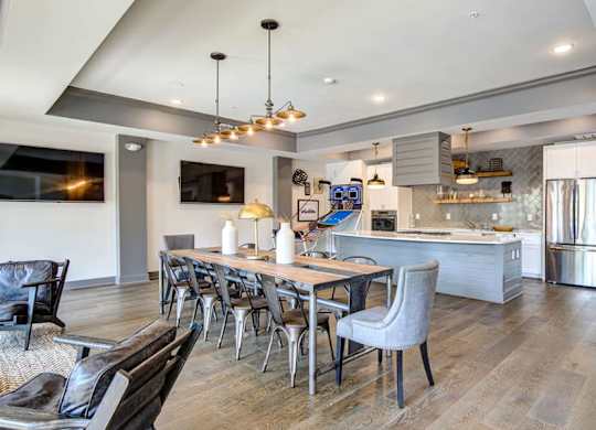 A modern kitchen with a dining table and chairs.