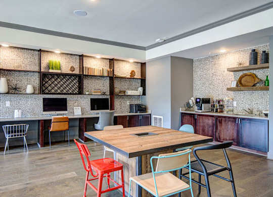 A kitchen with a wooden table and chairs.