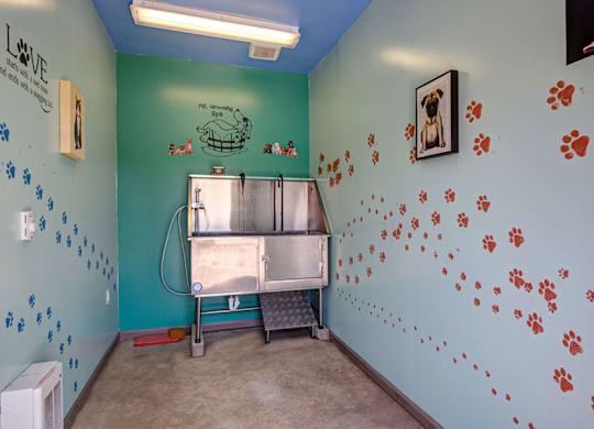 A room with a blue wall and a fridge.