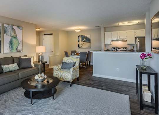 A living room with a grey couch and a coffee table.