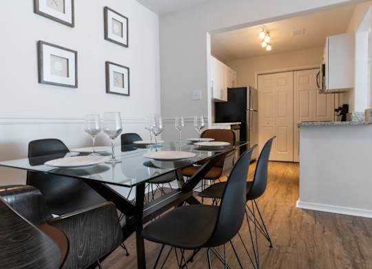 Pet-Friendly Apartments in Alpharetta, GA – Webb Bridge Crossing – dining room with a table and chairs and a kitchen in the background