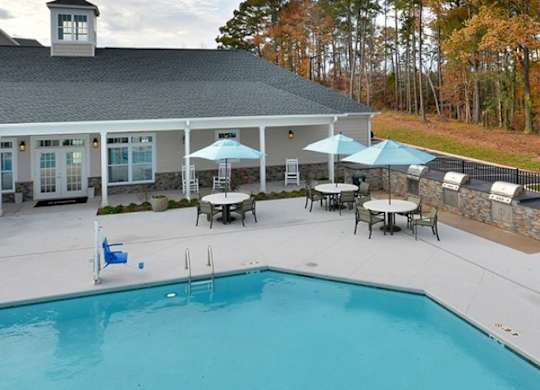 A pool with a building behind it.