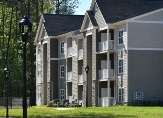 A large apartment building with a black lamp post in front.