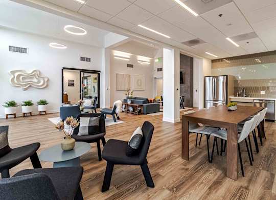 A modern living room with a dining area and kitchen in the background.