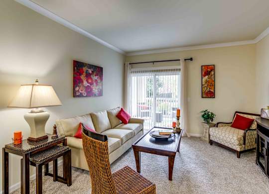 A living room with a couch, chair, and television.