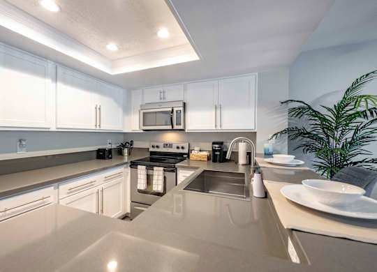 San Clemente CA Apartments for Rent - Rancho Del Mar - Modern Kitchen with White Cabinets, Stainless Steel Appliances, and Gray Countertops