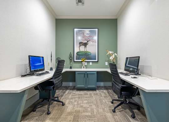 A room with two desks and two chairs.