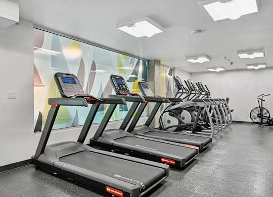 A gym with treadmills and exercise bikes.