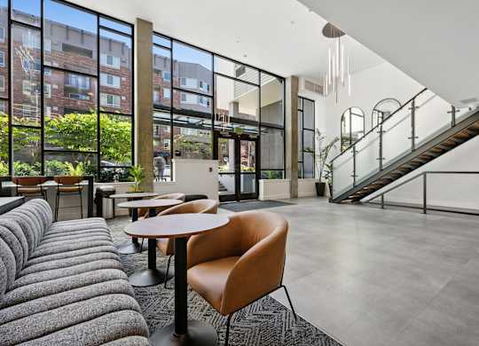 A modern interior with a grey carpet and a brown chair.