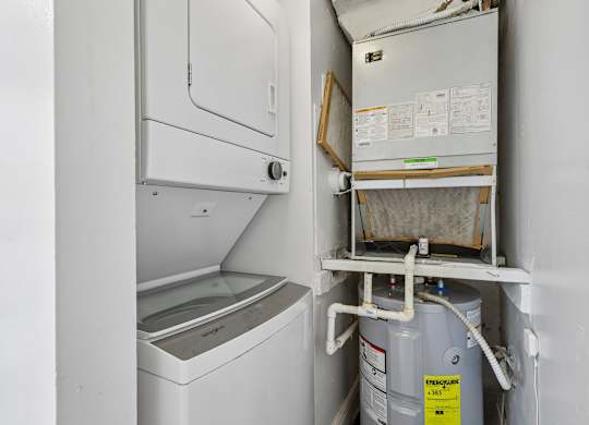 A white washing machine and dryer in a small laundry room.