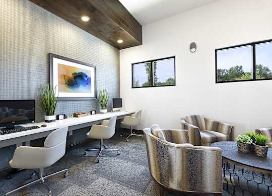 a modern office with chairs and a desk with a computer