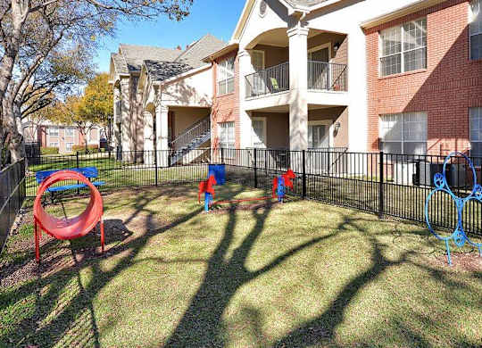 Plano Apartments for Rent - Carrington Park - Outside Pet Park with Jumping Hoops, Tunnel, and More Play Equipment