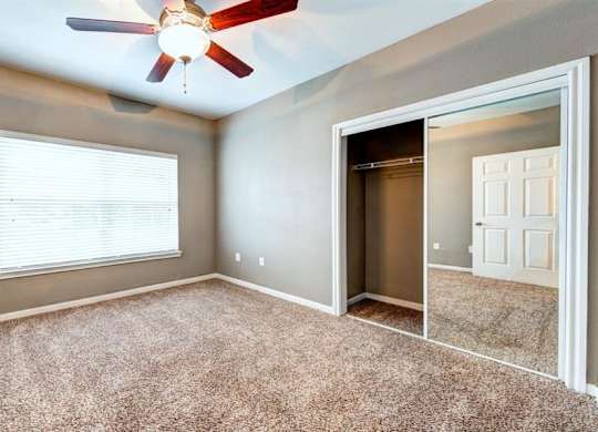 Bedroom with glass sliding closet doors