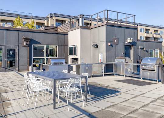 a patio with a table and chairs on the rooftop
