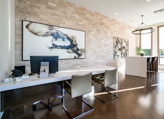 Apartments Santa Clara, CA - Villas on the Boulevard - Office with Desk, Computer Monitor, Chairs, Wall Art, Telephone, Chandelier Lighting, Hightop Table, and Hightop Chairs.