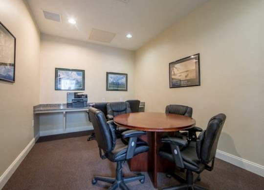 a conference room with a table and chairs