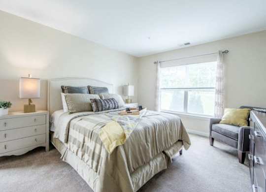 a bedroom with a bed sitting next to a window