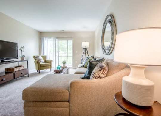 a living room filled with furniture and a flat screen tv