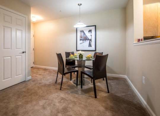a dining room with a table and chairs