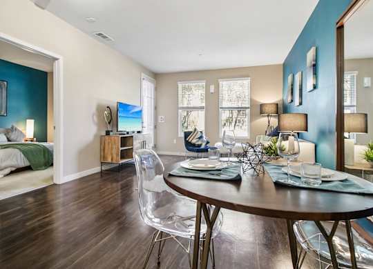 A dining room with a table set for two.