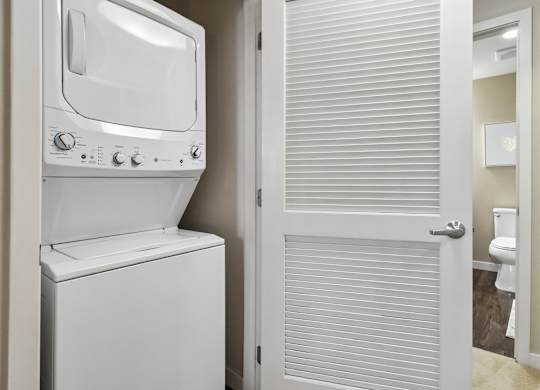 A white oven and toilet in a small bathroom.