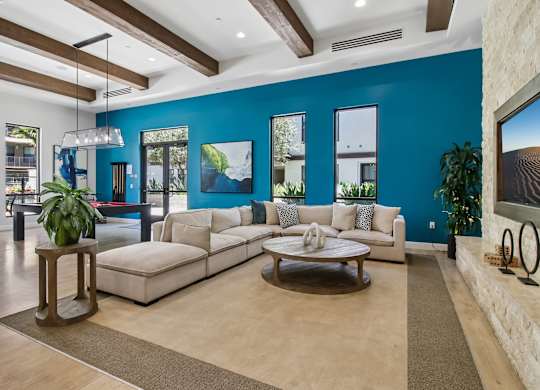 A living room with a white couch and a wooden coffee table.