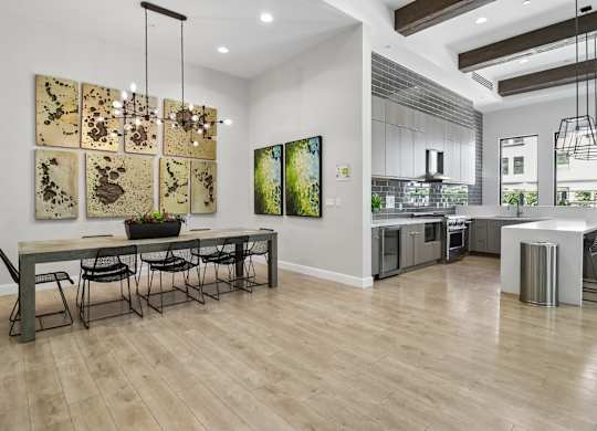 A modern dining room with a long table and chairs.