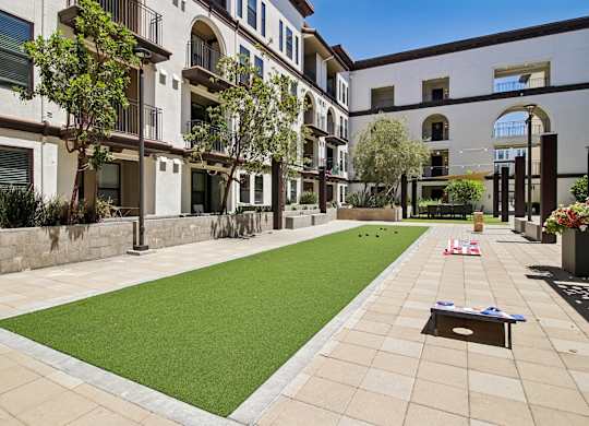 A grassy area in front of apartment buildings.