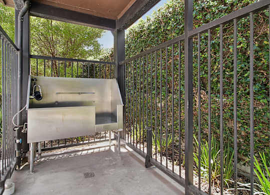 A metal gate with a screen door is closed.